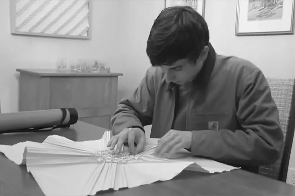 Charlie Weitzenberg folding an origami tessellation