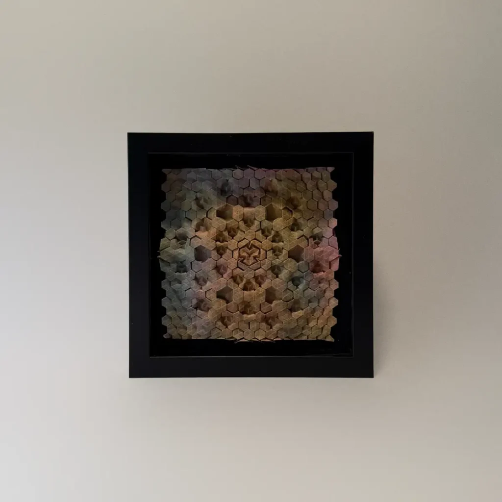 Intricate origami tessellation framed artwork by Charlie Weitzenberg