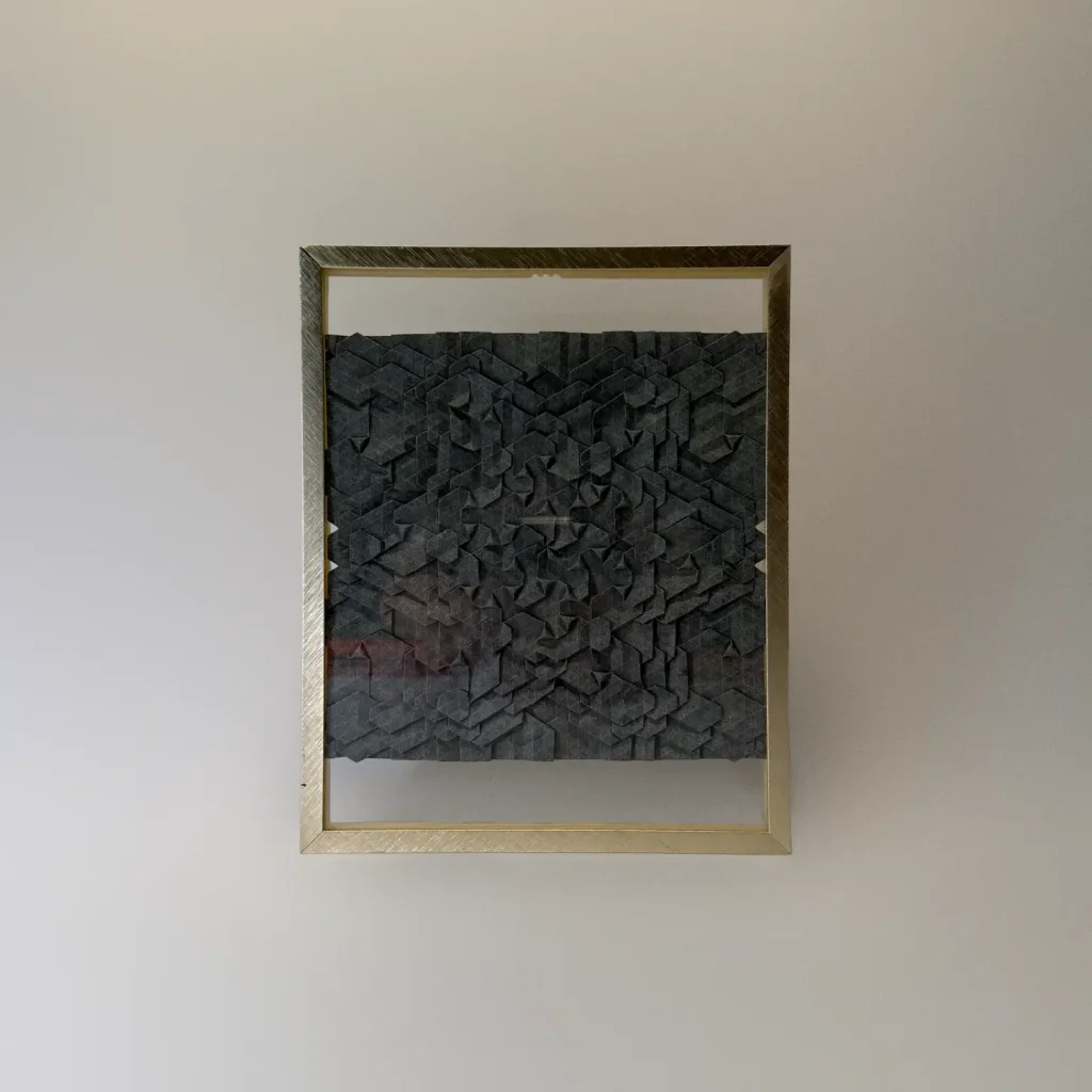 Intricate origami tessellation framed artwork by Charlie Weitzenberg