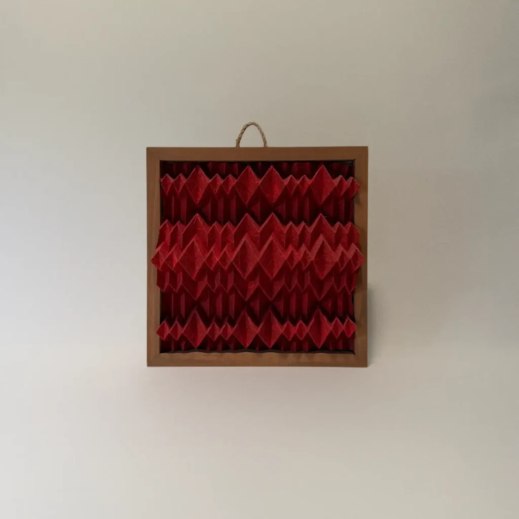 small red framed origami tessellation artwork by Charlie Weitzenberg